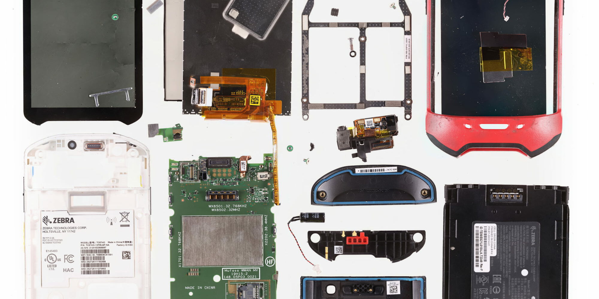 Gigapixel teardown image of a Zebra TC67HO enterprise handheld computer, showing the logic board, battery, barcode scanner module and flex cable assemblies